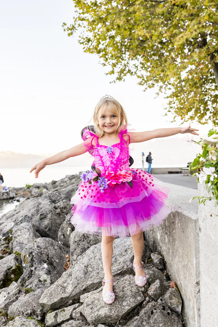 young girl dressed up stood on rocks