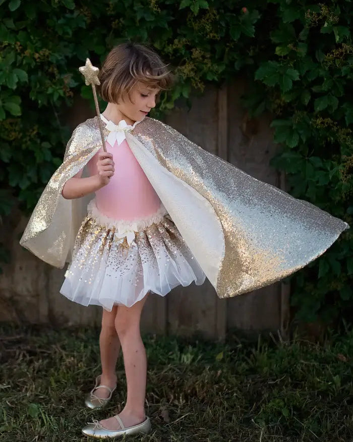 young girl playing in her cape and fairy set