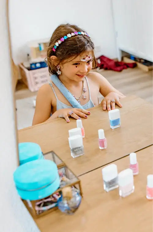 young girl playing with nail polish