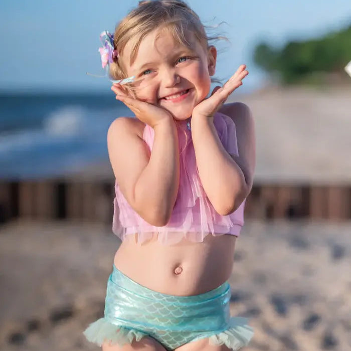 girl holding head smiling