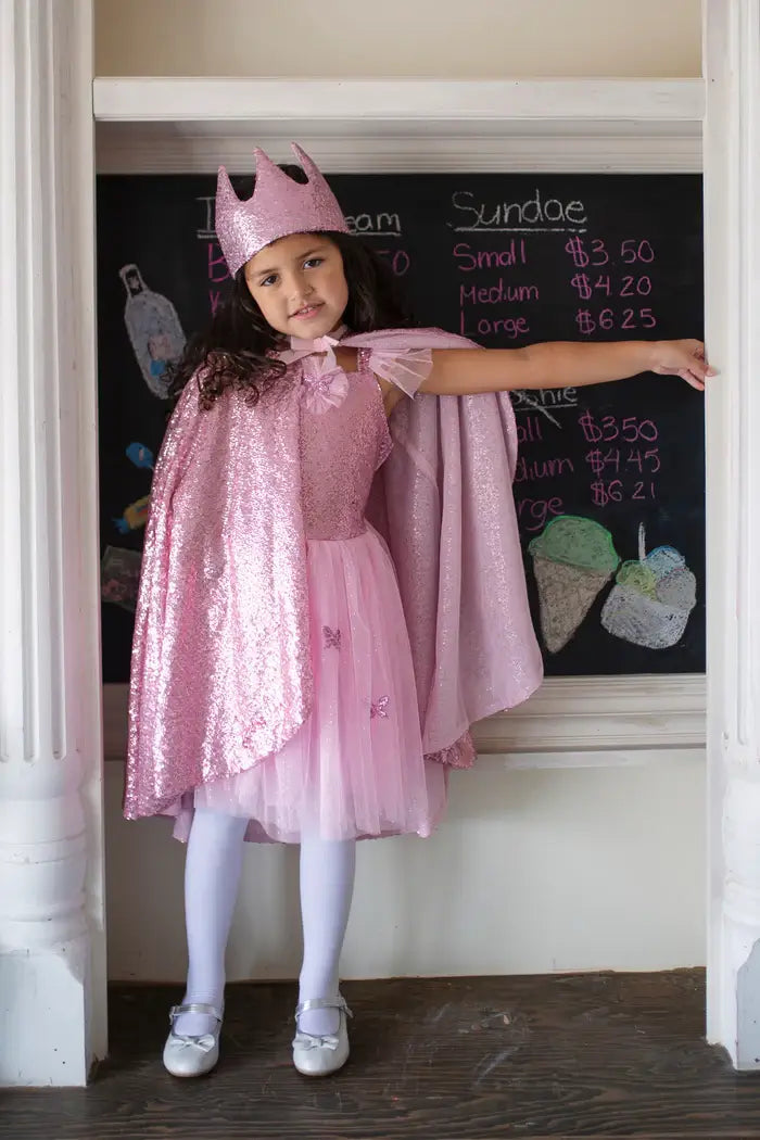 Young girl wearing matching dress, hat and cape