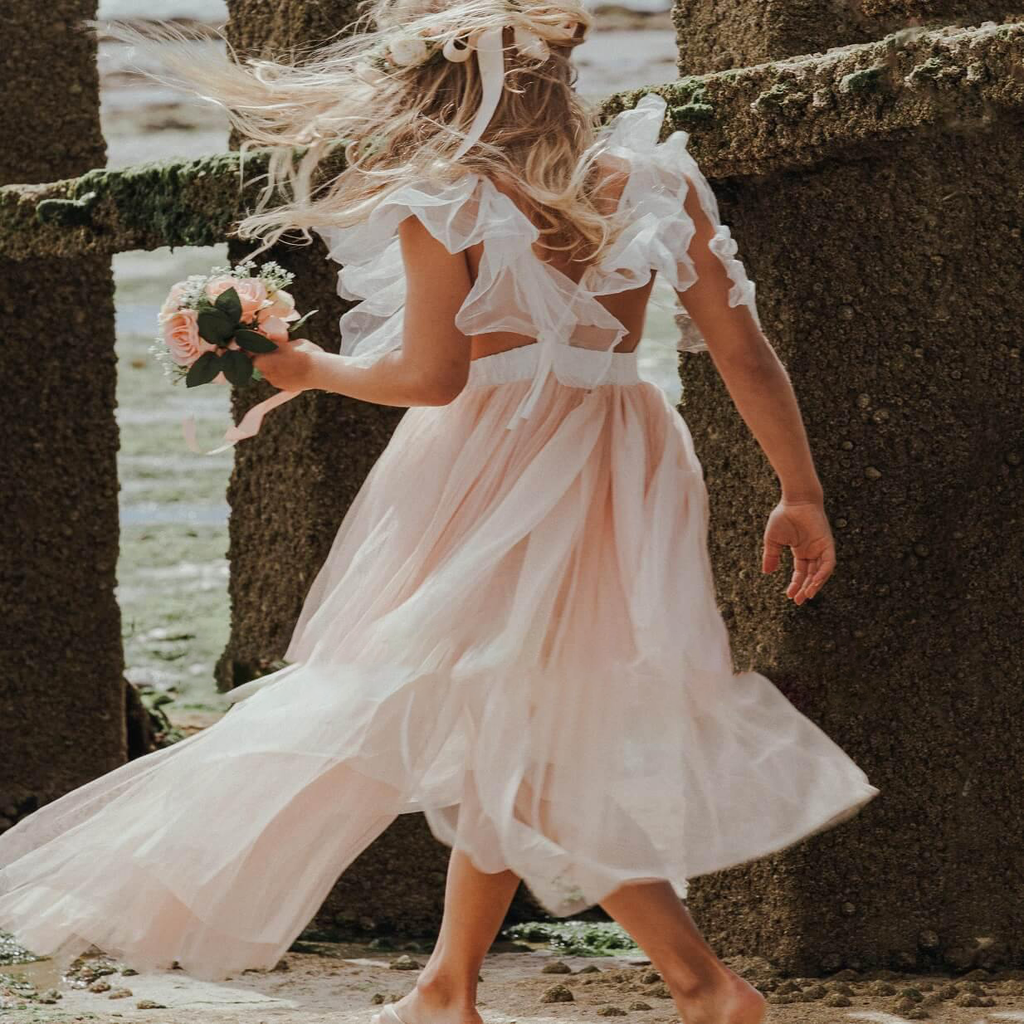 Girl in pretty dress at beach