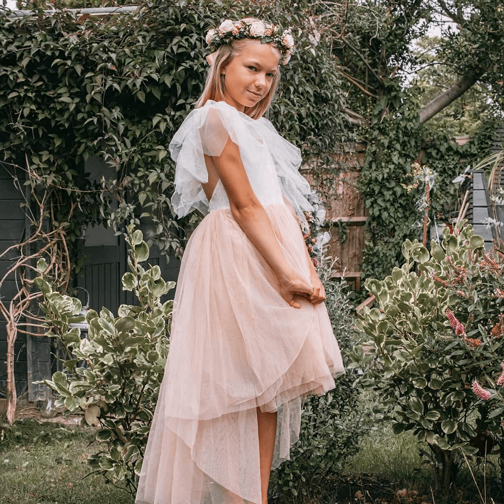 girl in garden wearing a Bohemian flower girl Dress