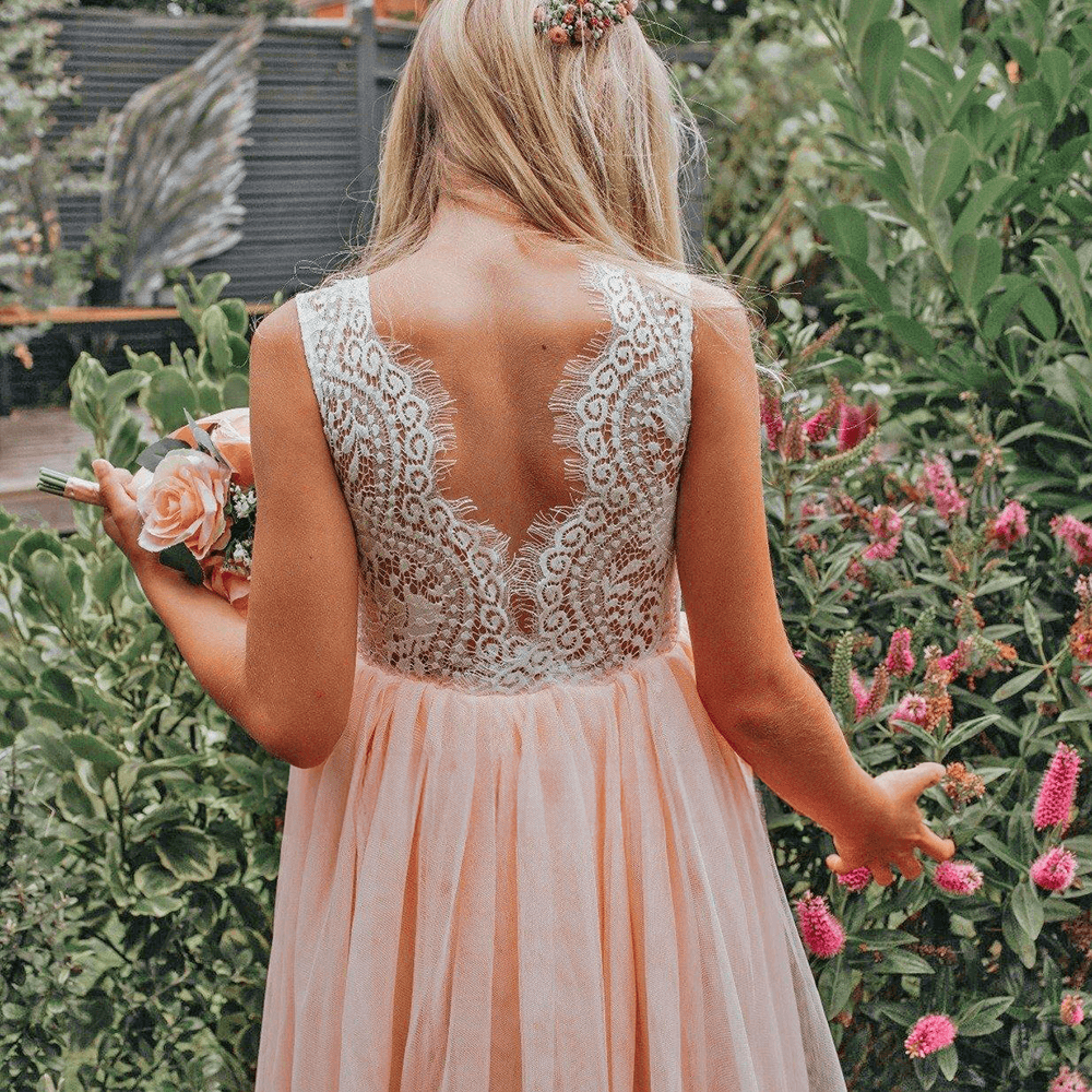 Girl in a garden wearing blush pink dress