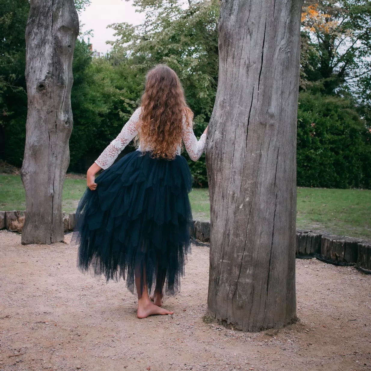 girl holding onto tree