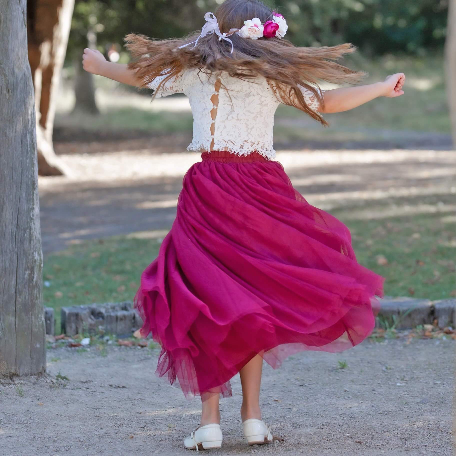 Grirl twirling in a lace party outfit