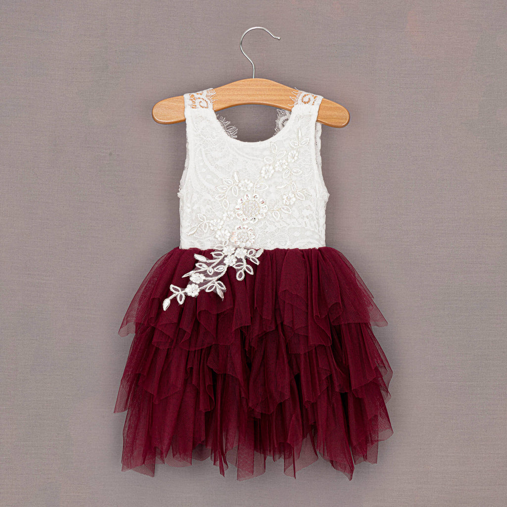 Deep red pretty girls dress on wooden hanger 