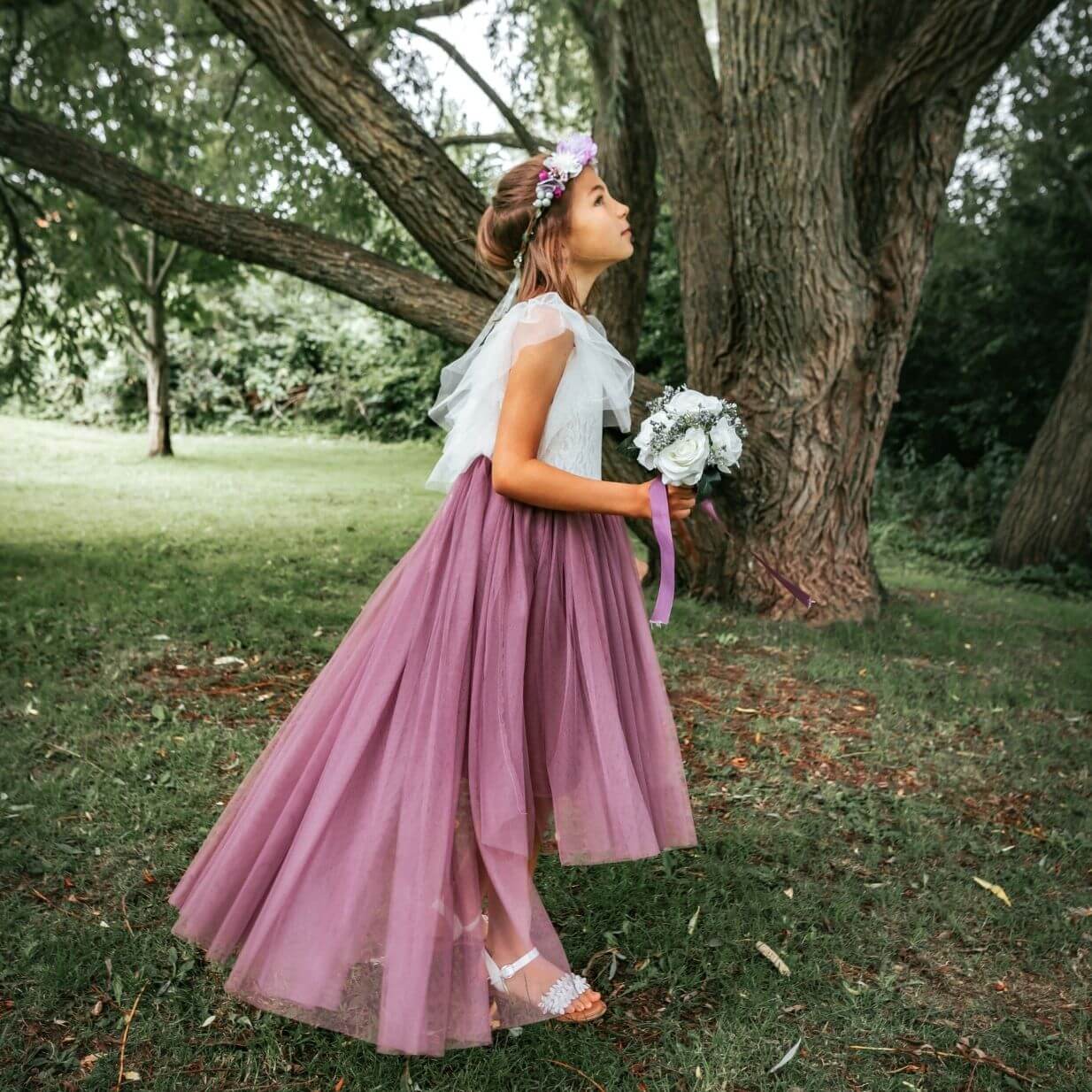 Flower girl playing in woods