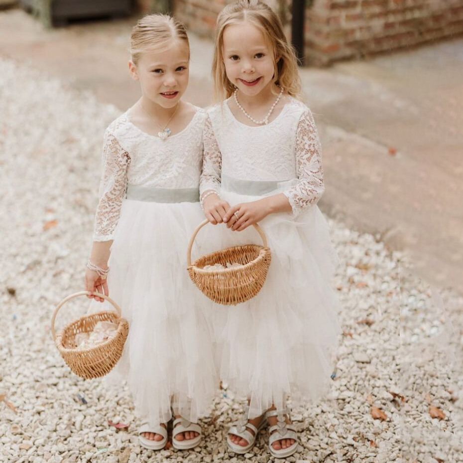 Two little flower girls holding baskets