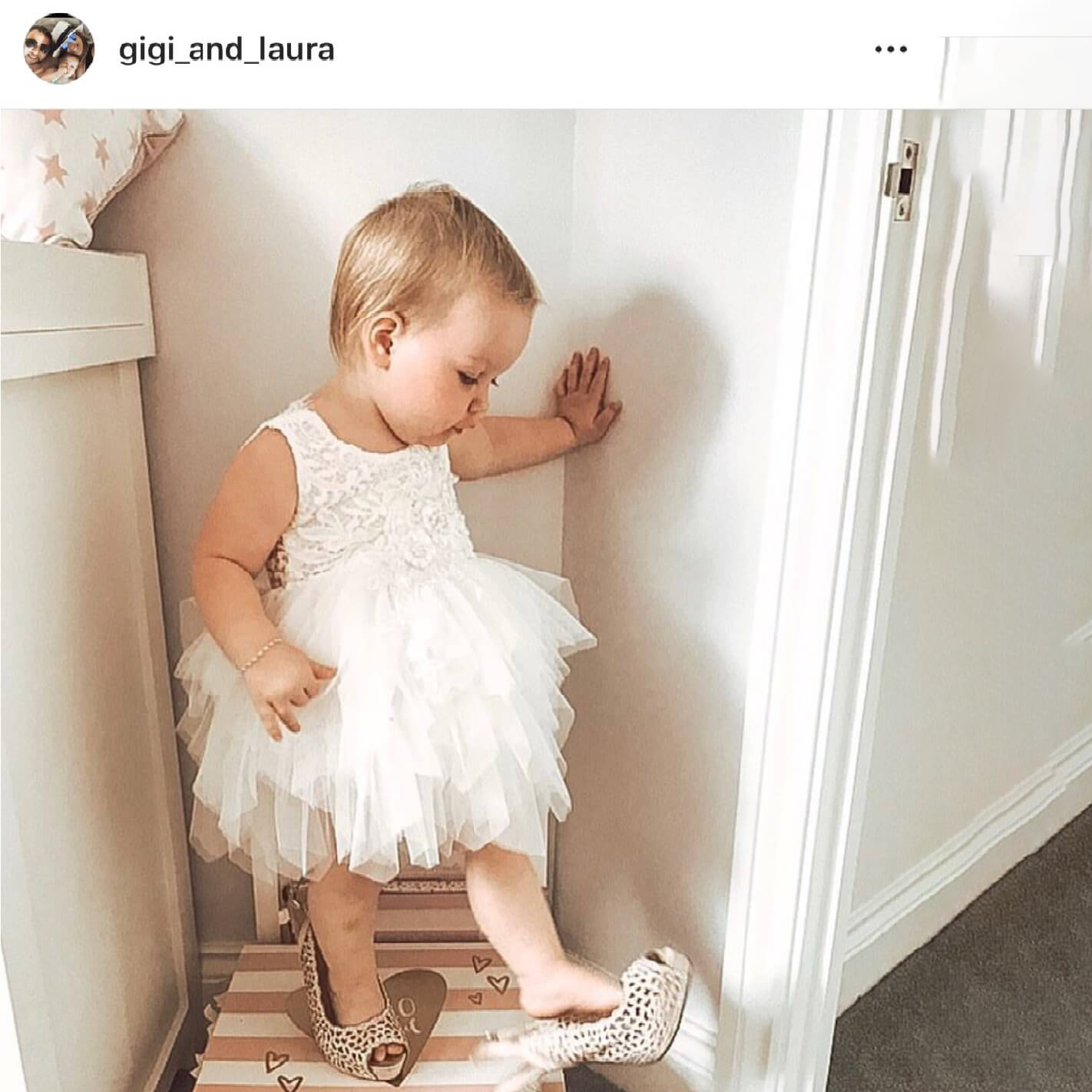 Baby girl wearing ladies shoes