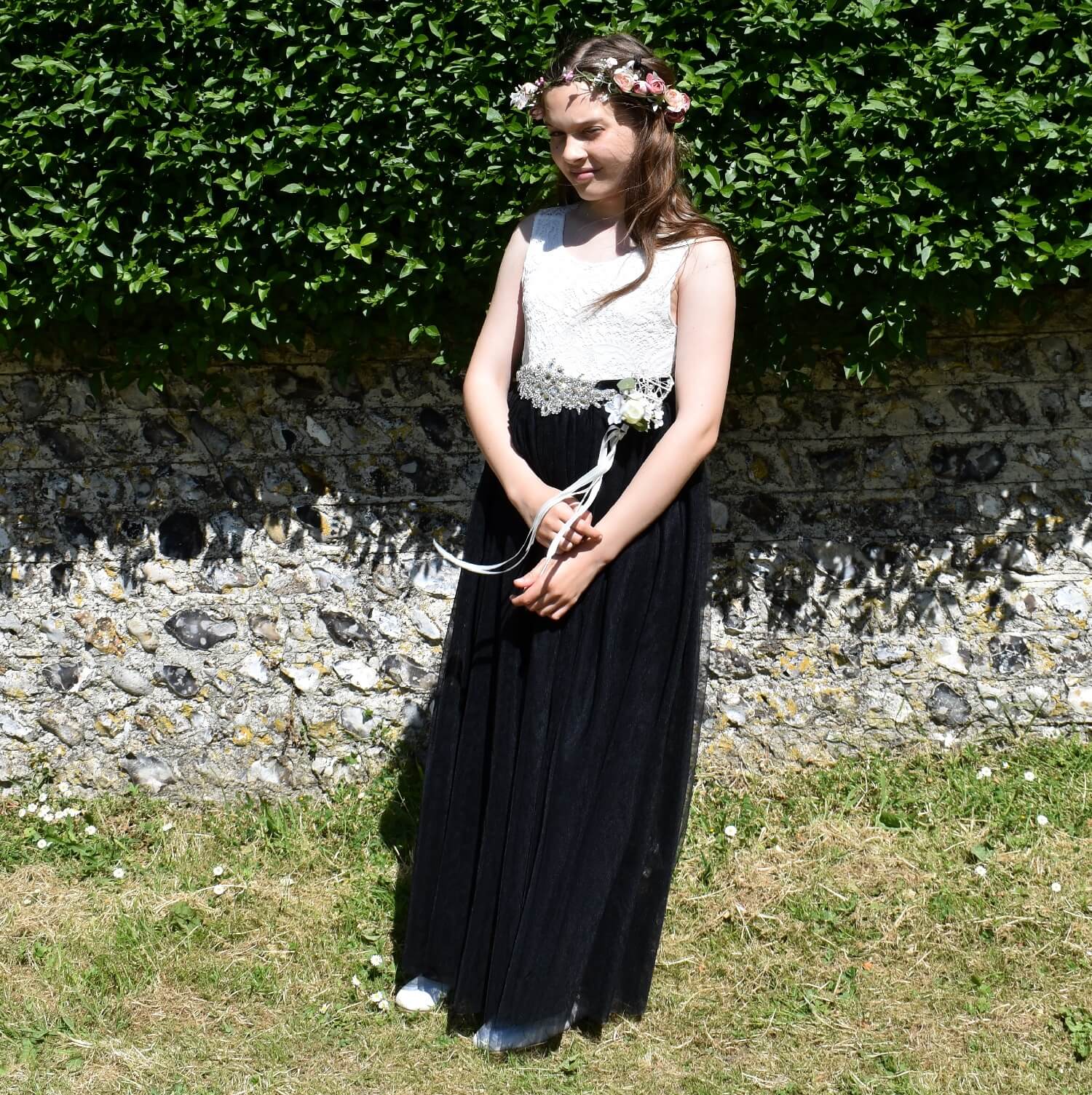 Young girl wearing flower dress and holding wand