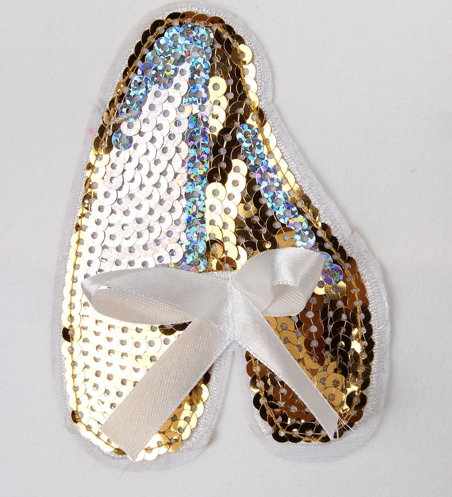 gold sequin slipper motif on a white leotard