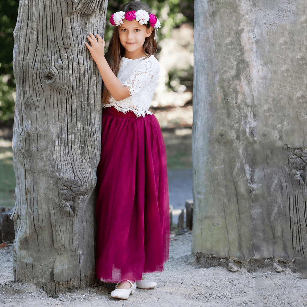 Girl in Felicity Couture party set holding a tree