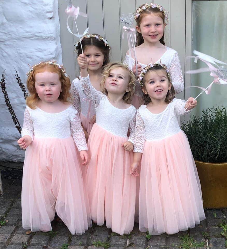 Girls waving flower wands