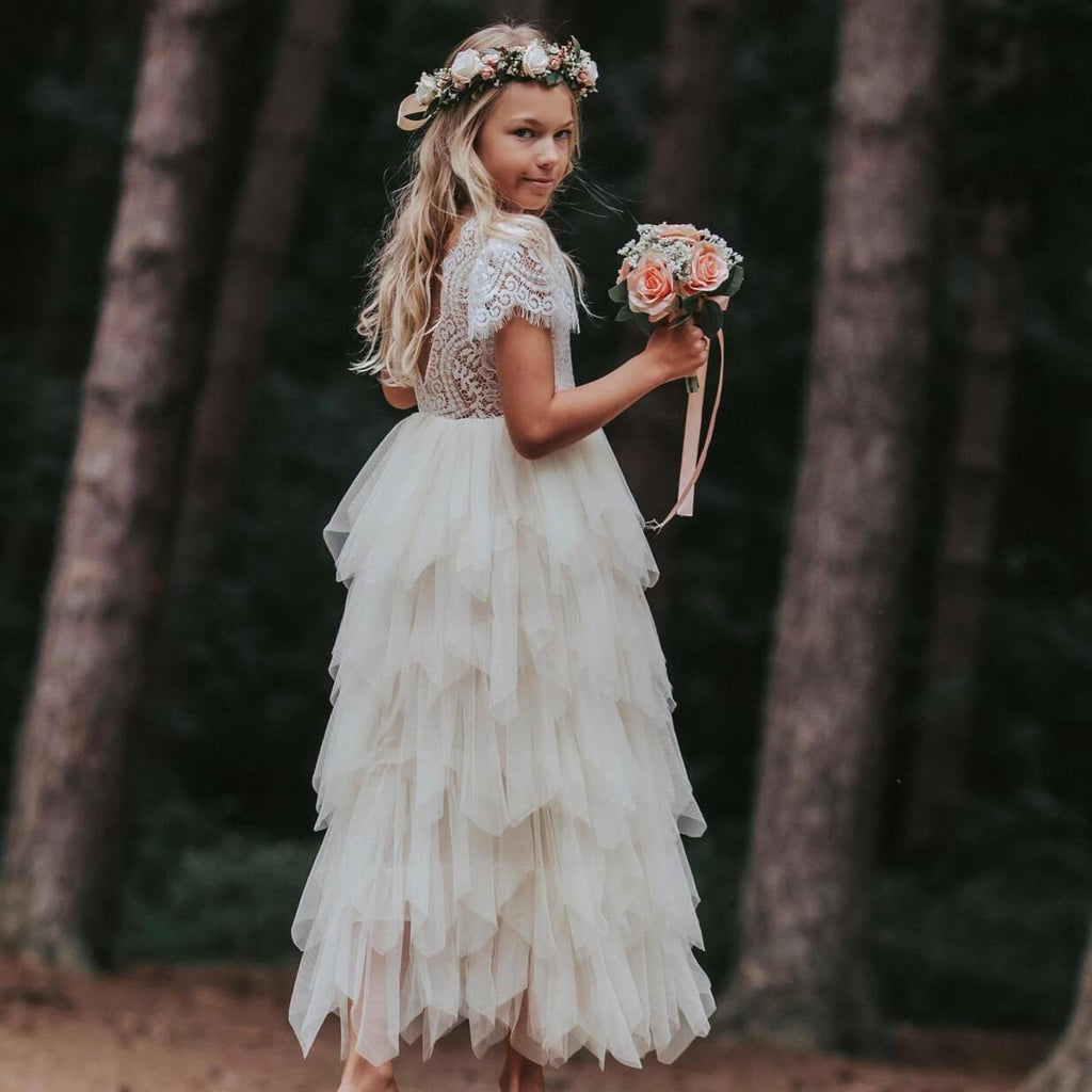 Beautiful young girl wearing dress holding bouquet