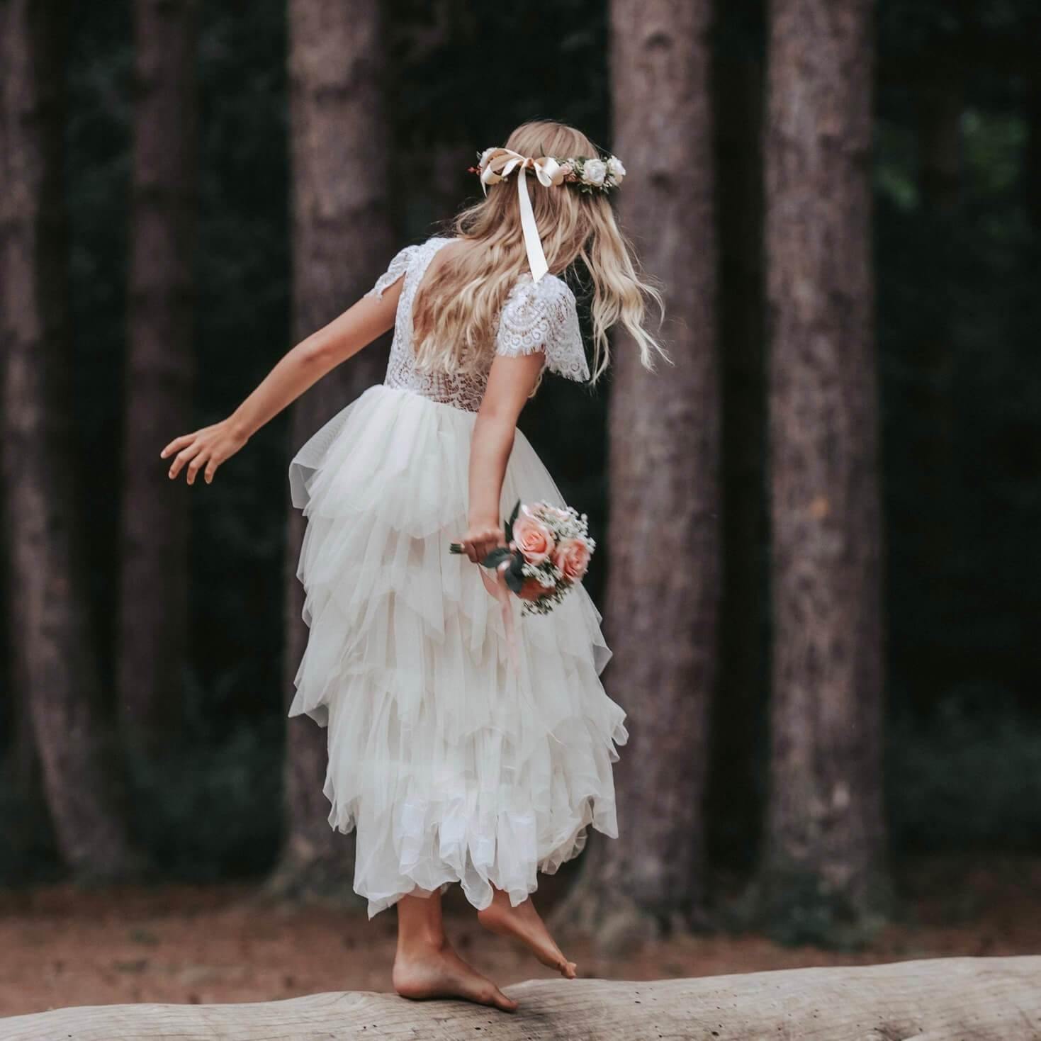 Girl dancing on log in forest