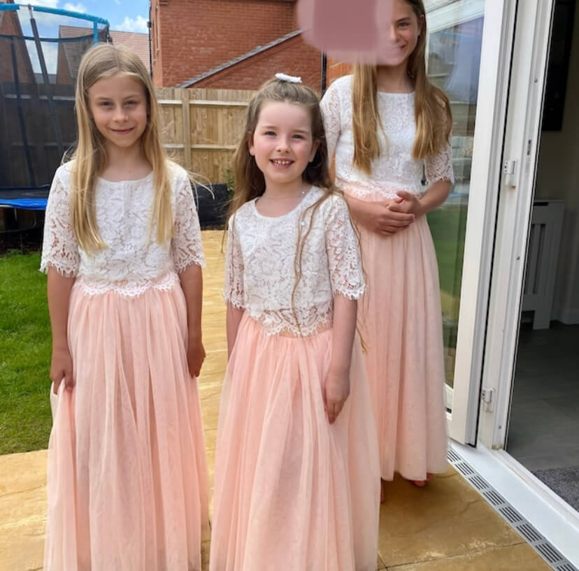 3 young flower girls in garden