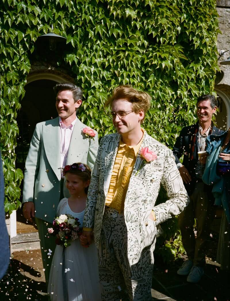 Two men getting married with flower girl