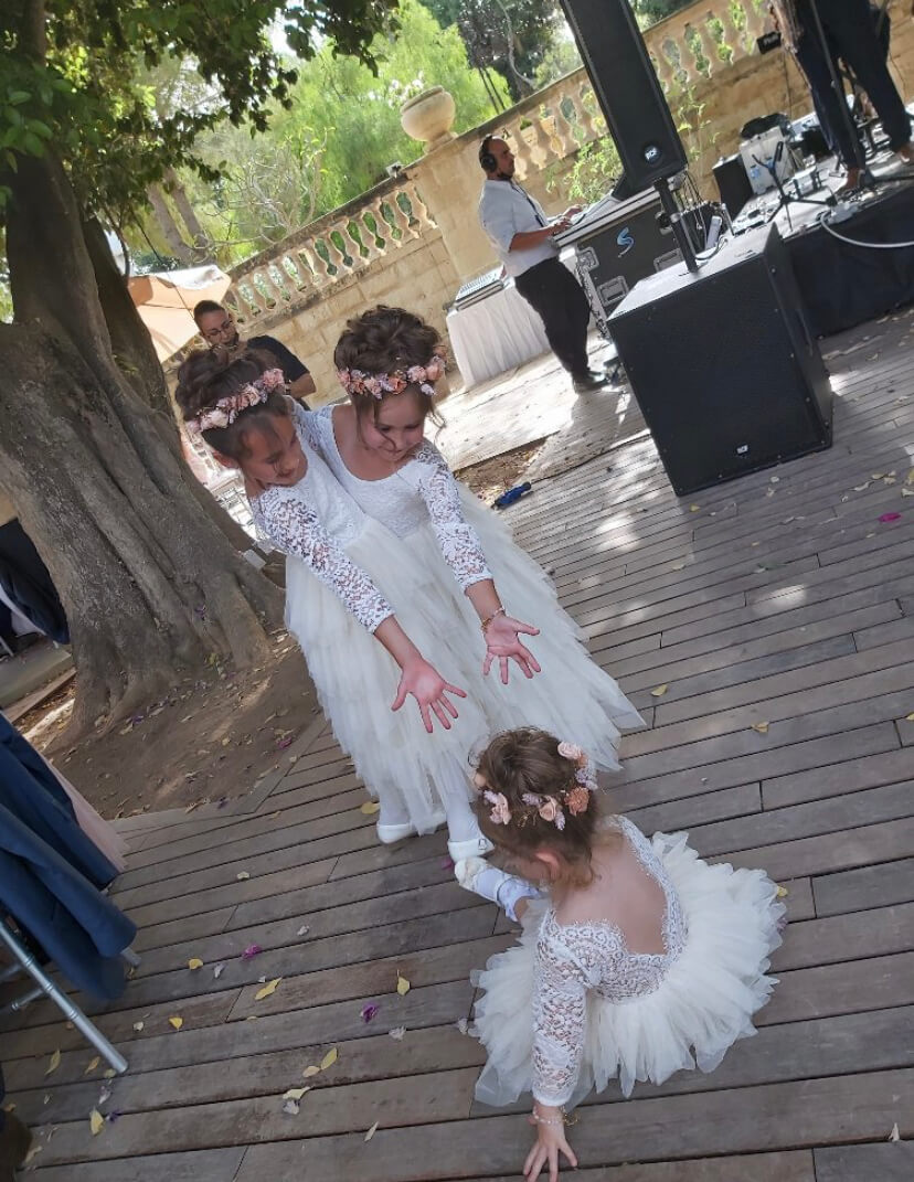 Flower girls holding their hands out