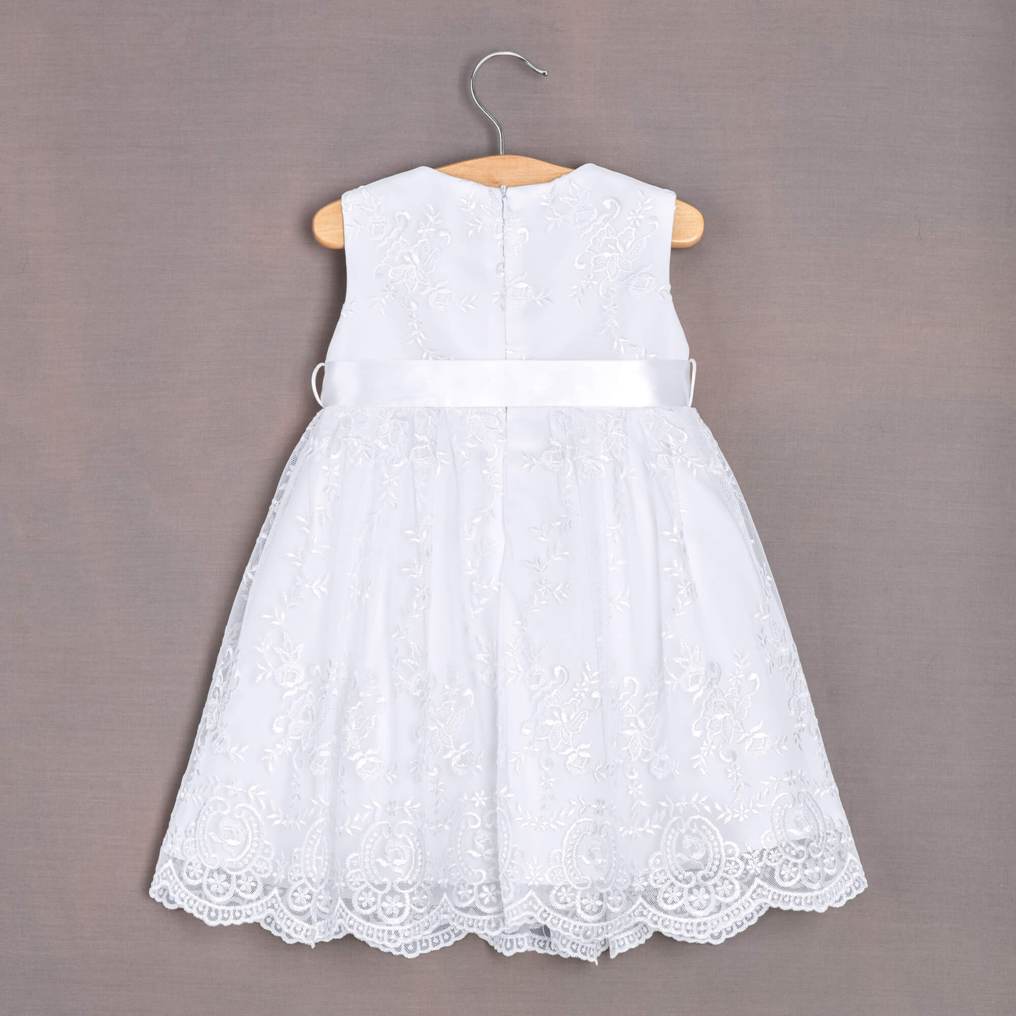 Rear of white dress hanging on hanger