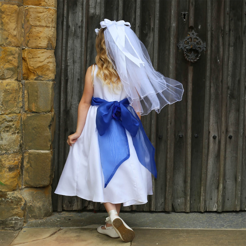Back of a girl in a white flower girl dress with a blue bow