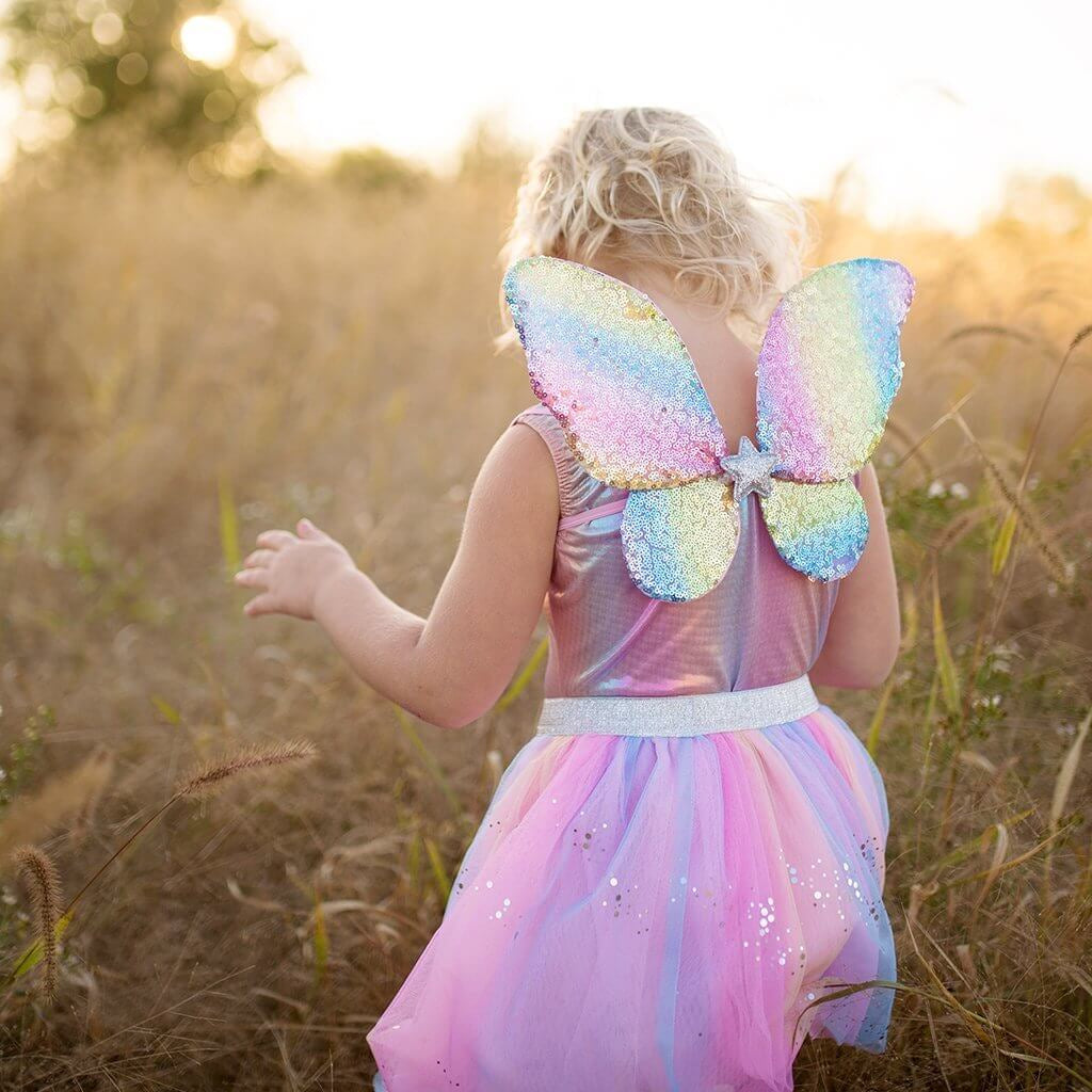 Back view of young girl in sequin rainbow fairy wings and matching tutu skirt