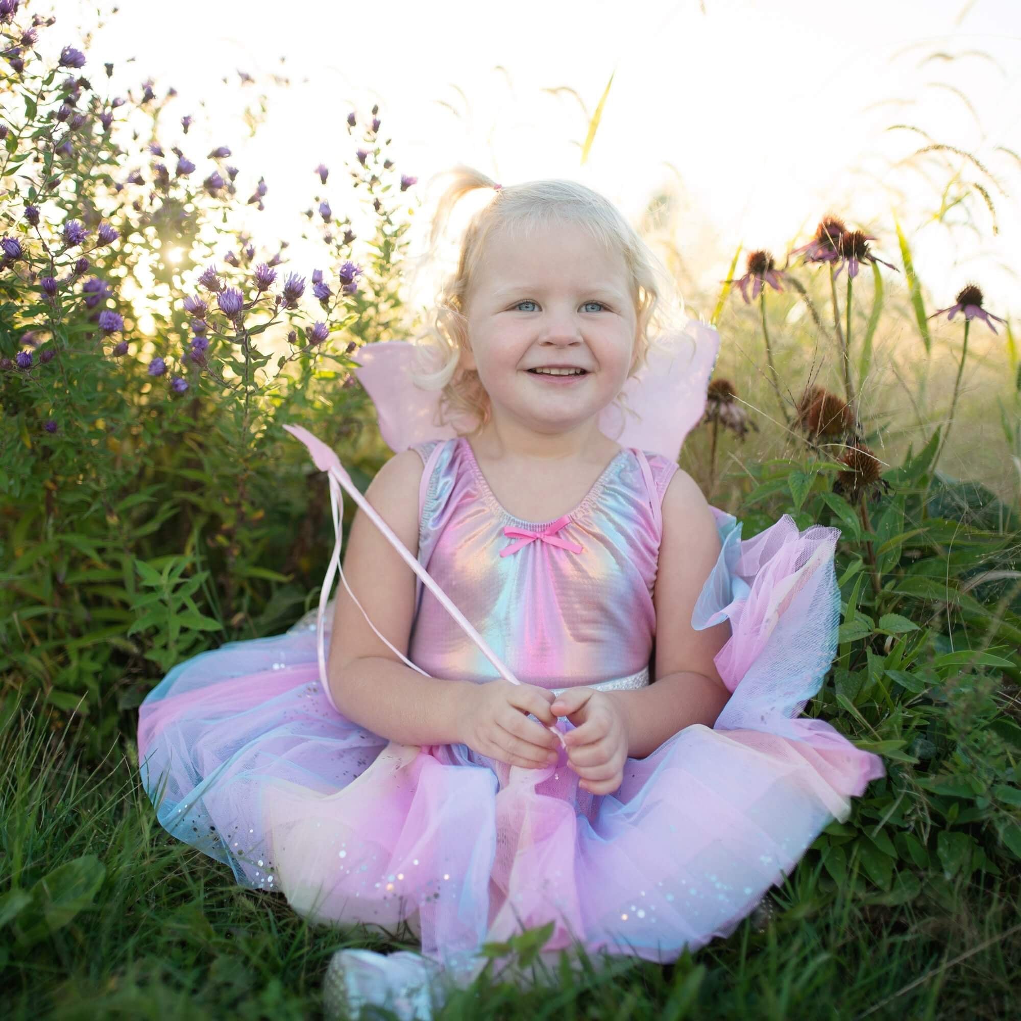 Picture of young girl dressed in rainbow iridescent leotard with matching rainbow tutu skirt and wand