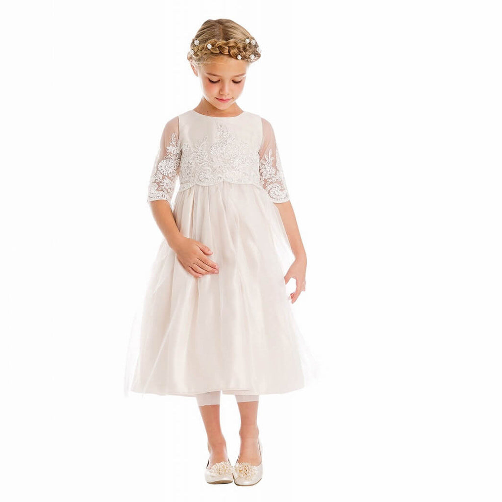 Girl wearing white flower girl dress