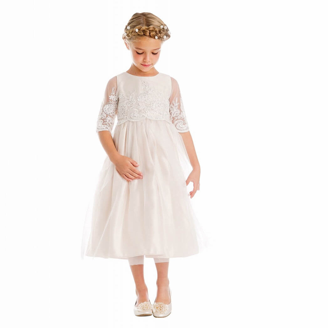 Girl wearing white flower girl dress