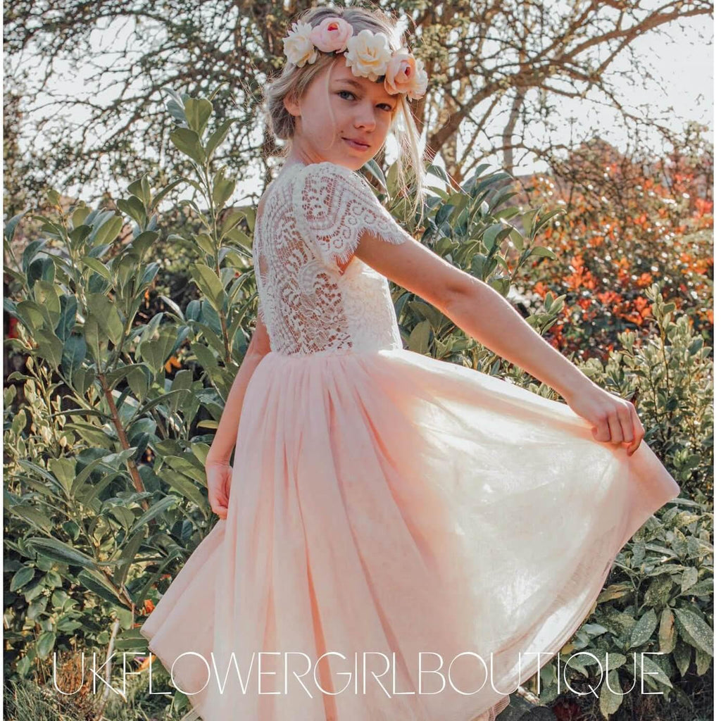 Gril twirling in a pink and white party dress