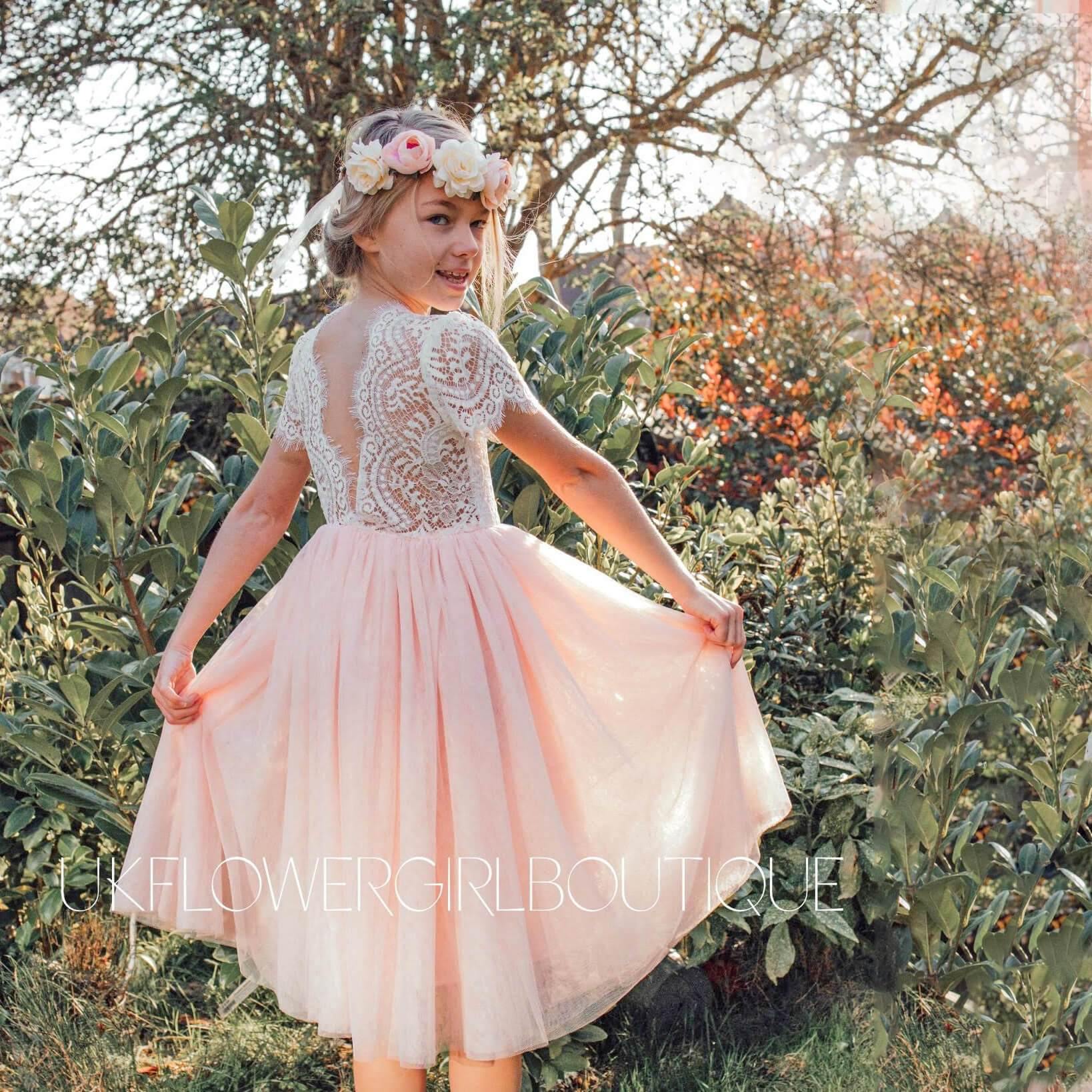Gril twirling in a pink and white party dress