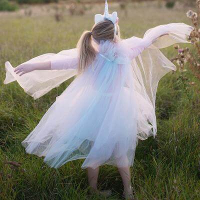 back view of girl wearing organza tutu skirt and cape with unicorn headband