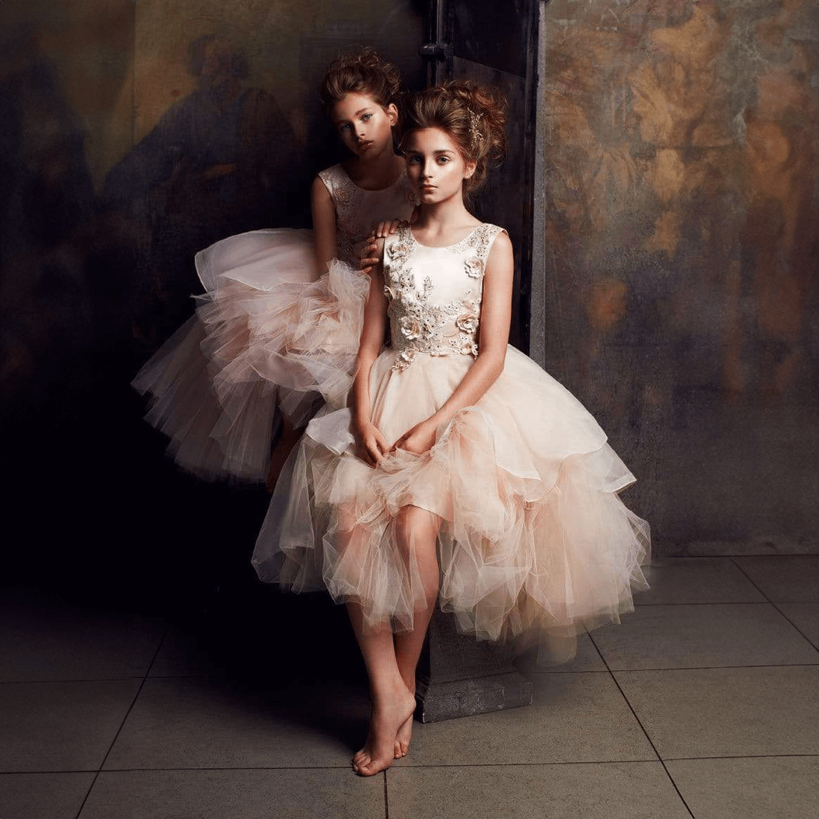 two Models wearing blush coloured Princess Evangeline party dresses