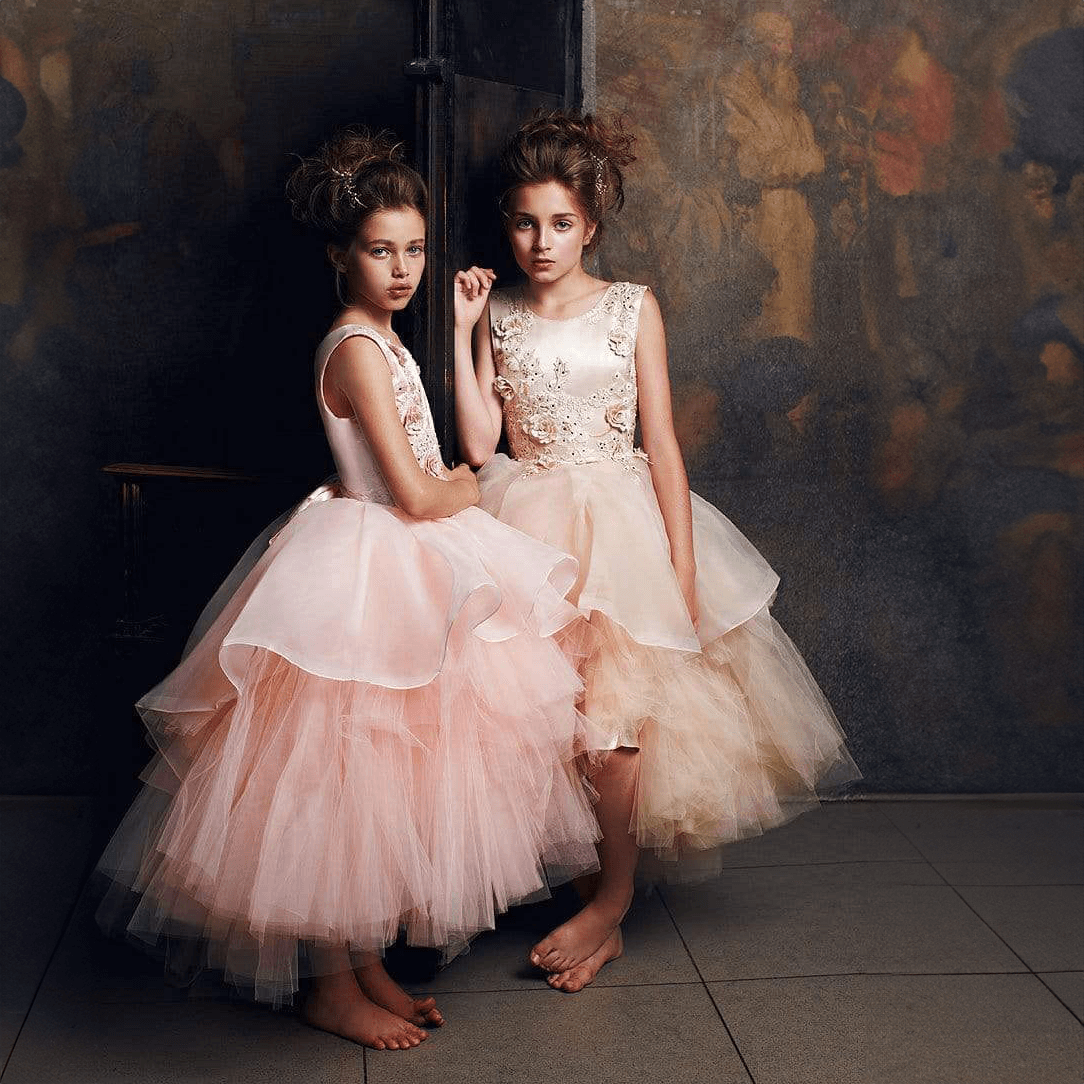 girls wearing a blush coloured Princess Evangeline party dress