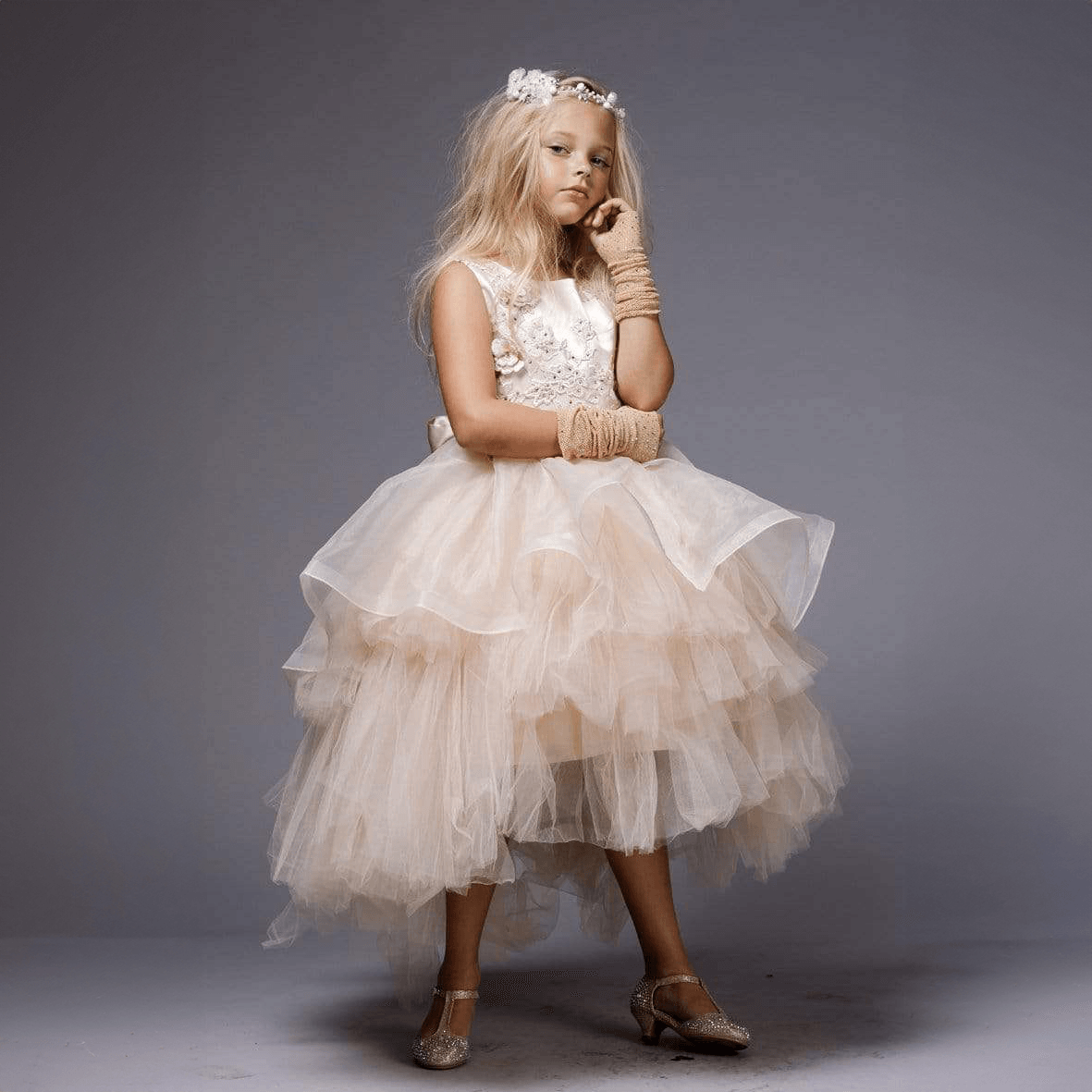 Girl wearing a blush coloured Princess Evangeline party dress
