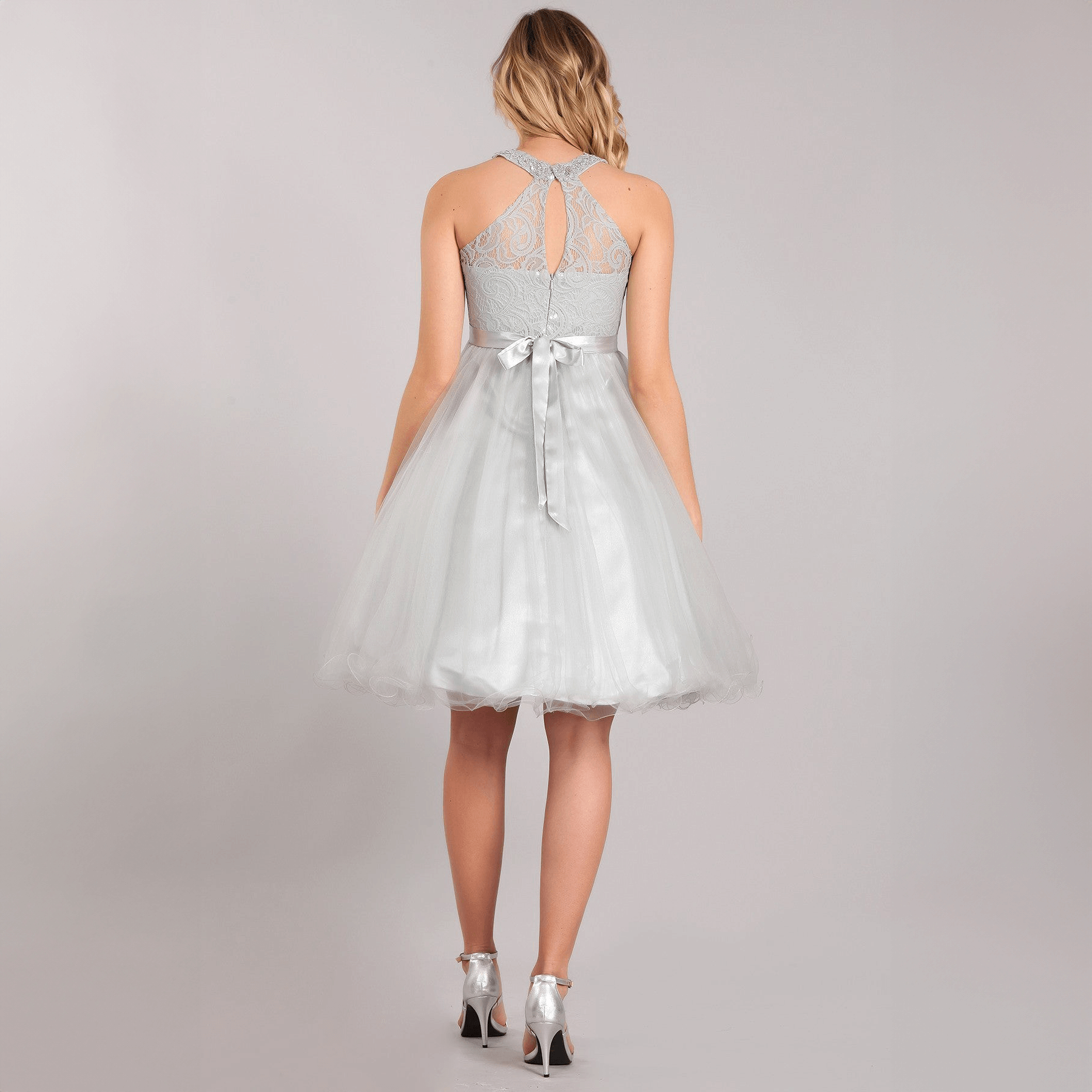 teenage model wearing a champagne coloured beaded halter neck dress from The Fairy Princess Shop