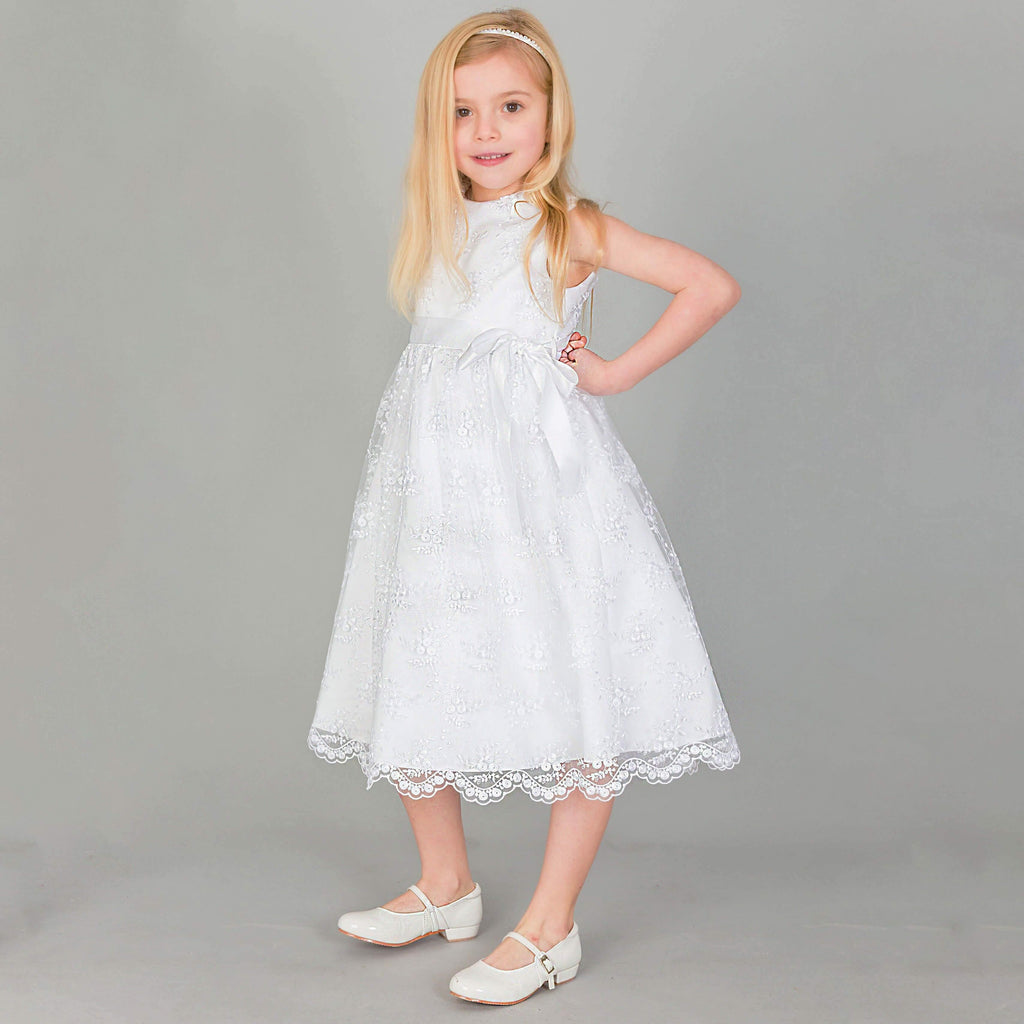 Girl posing in white flower girl dress