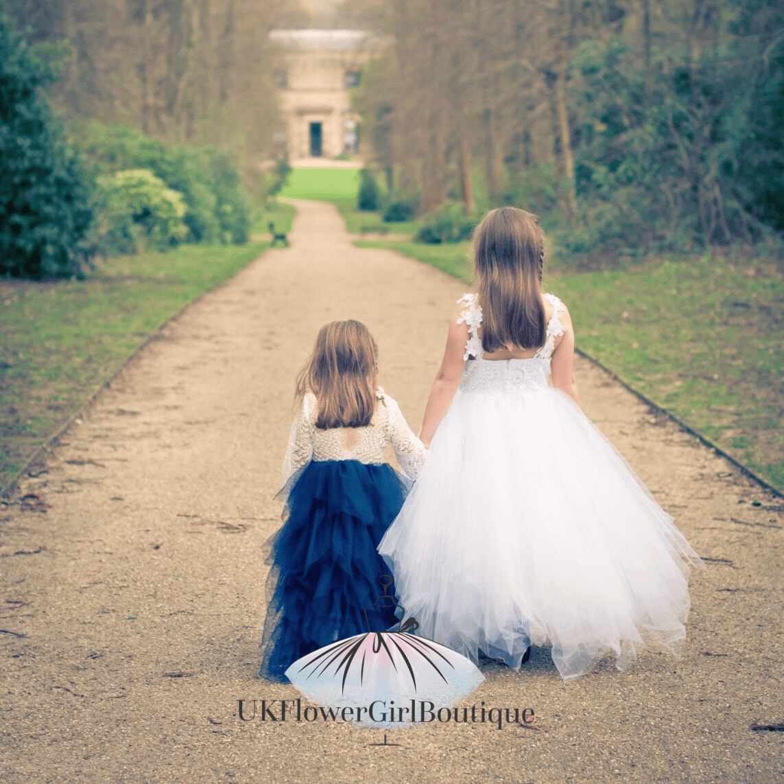 two girls in party dresses in a garden