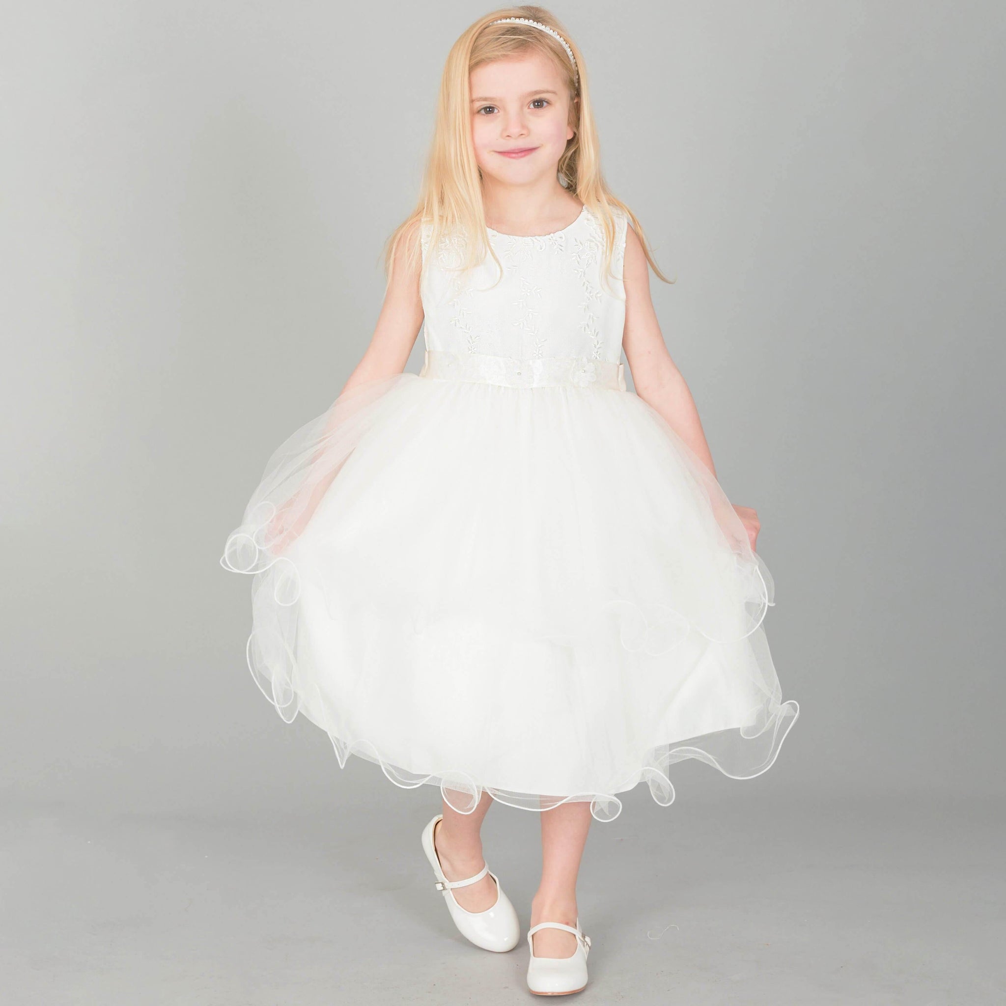 Girl wearing UK Flower Girl Boutique ivory coloured Tiffany dress