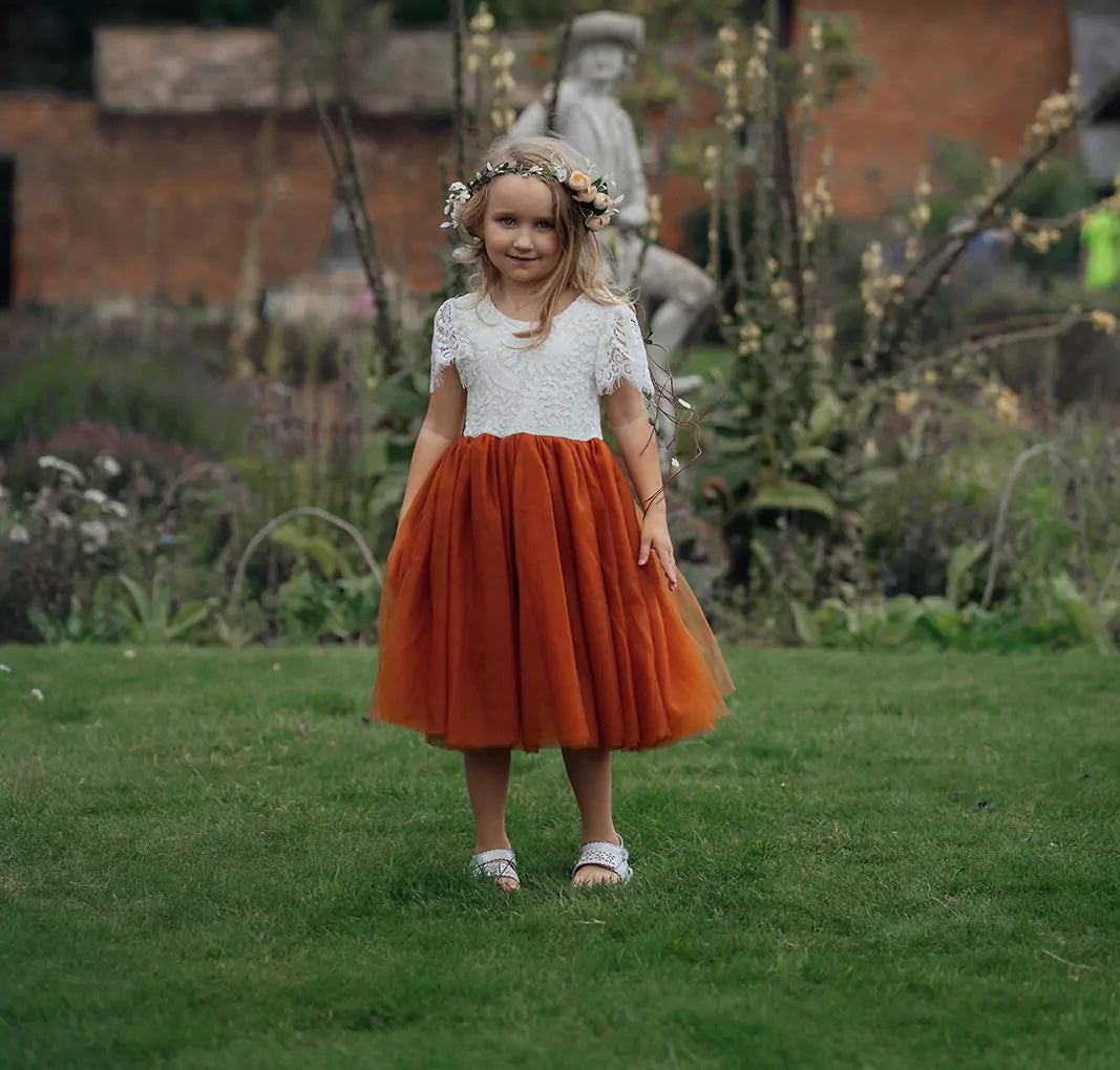Young girl wearing burnt orange dress