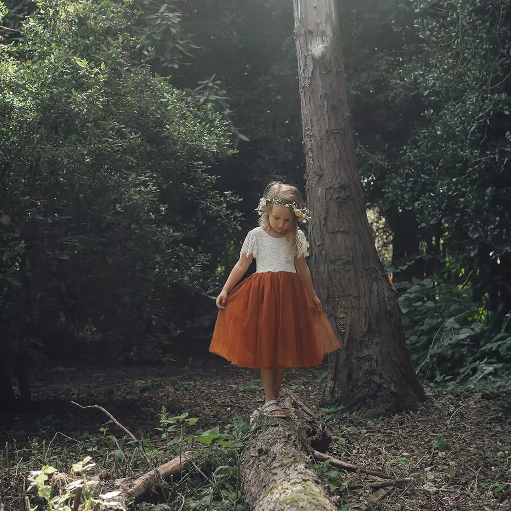 Flower girl playing in woods