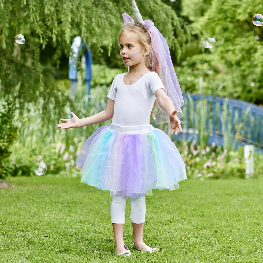 girl wearing a Pastel coloured glittered layers of tulle and feature unicorn horn headband dress up set