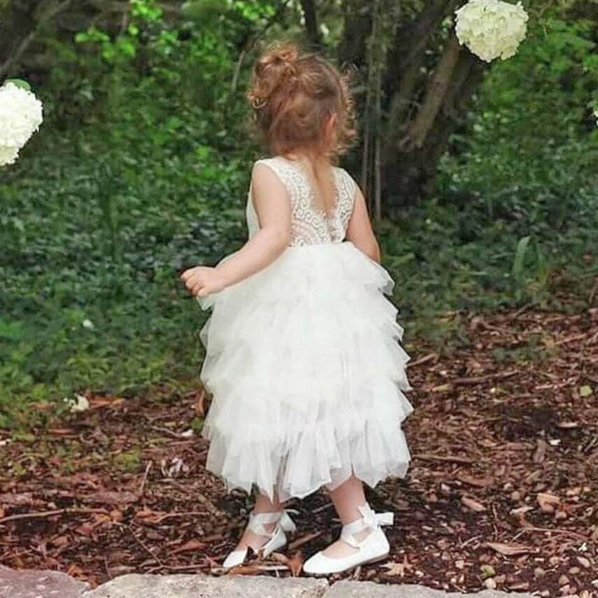 Girl in white sleeveless flower girl dress