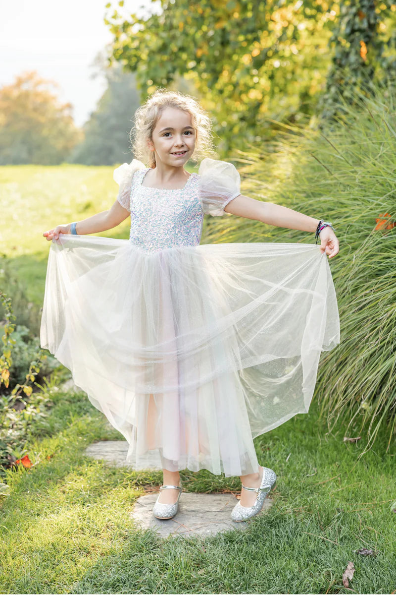 Young girl in a white dress standing in a garden