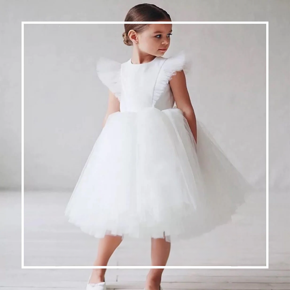 Gril wearing a white occasion dress from UK Flower Girl Boutique