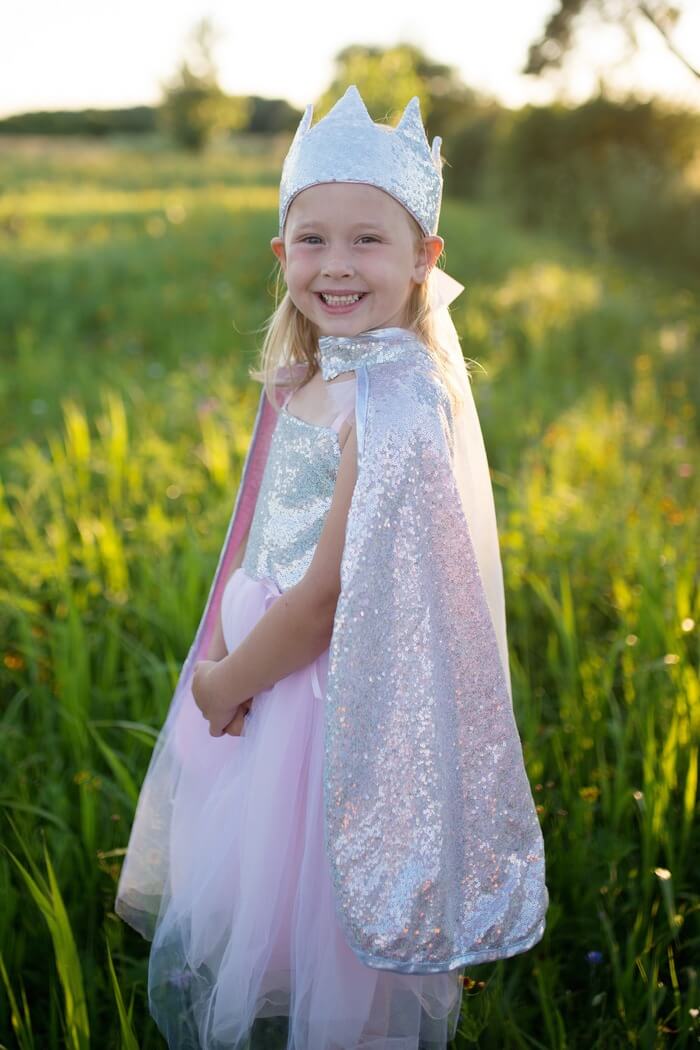 smiling girl wearing the fairy dress up cloack