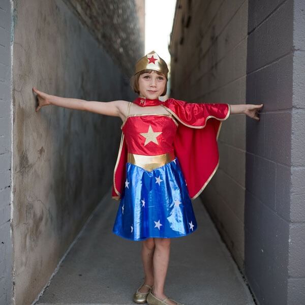 Girl wearing a Superhero Tunic, Cape and Headpiece 