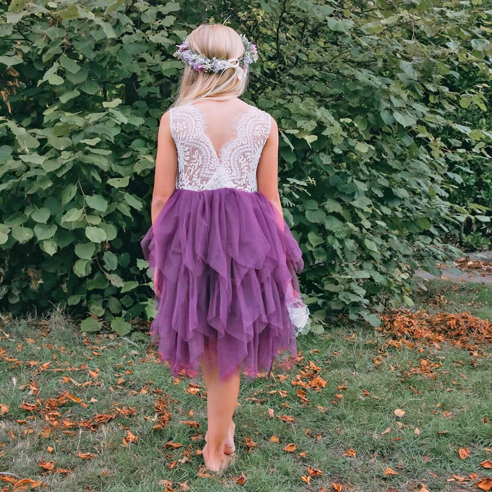 Girl in a garden wearing a Purple Flower Girl Dress