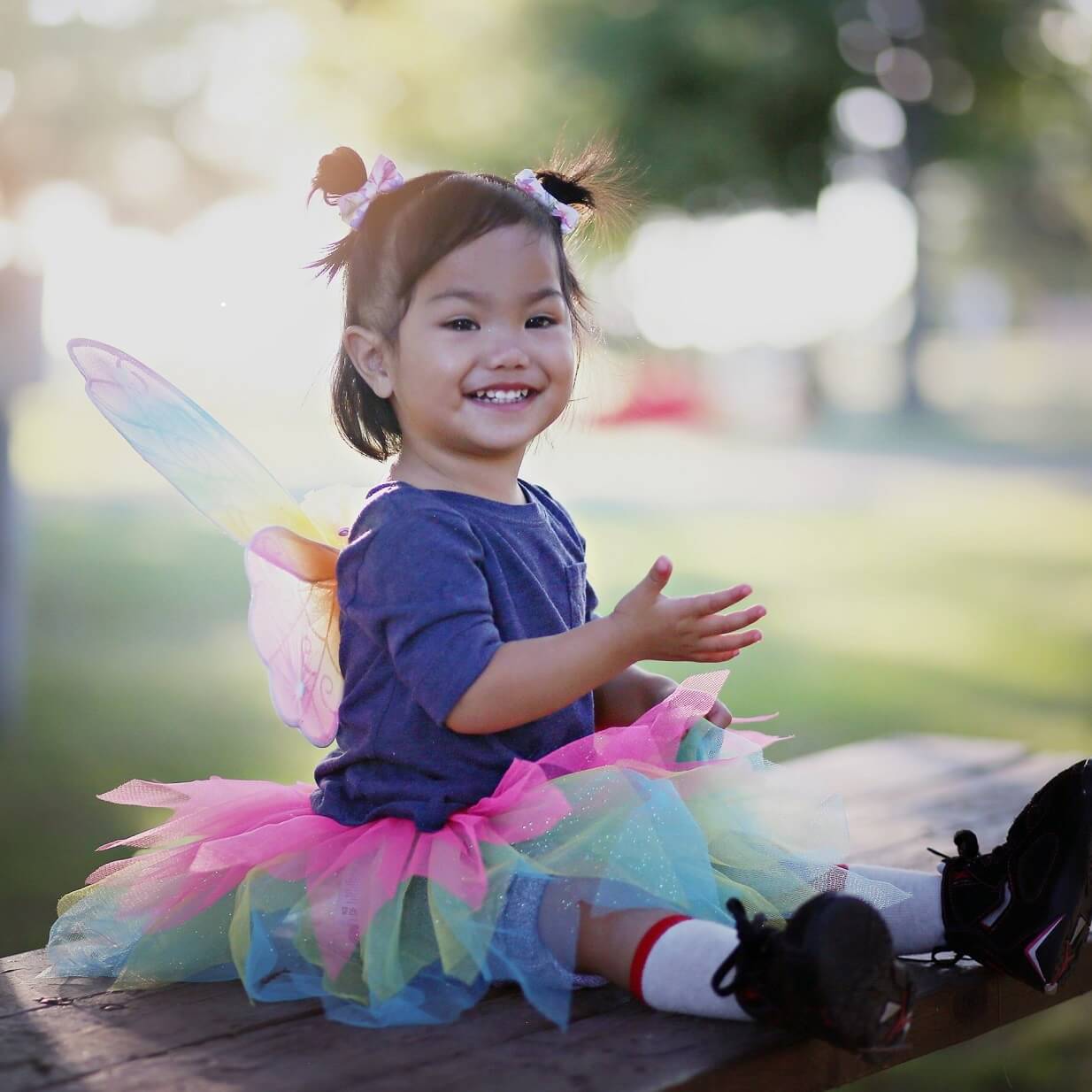 Girl playing happily in fairy set