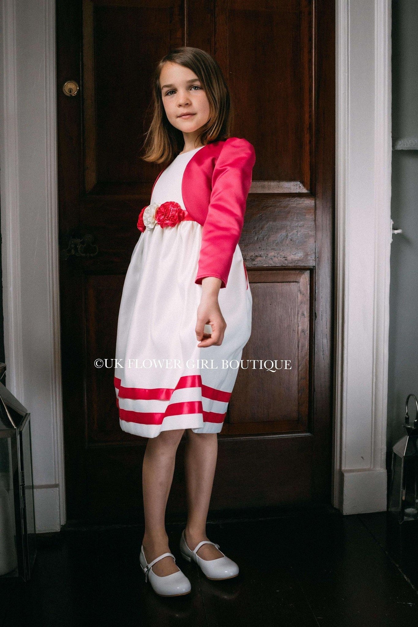 Young girl holding dress wearing matching bolero